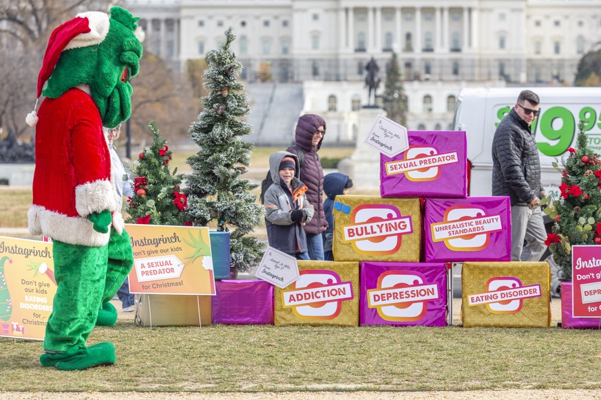 IMAGE DISTRIBUTED FOR PARENTSTOGETHER - The &quot;Instagrinch&quot; stares down a passing child while delivering gifts to Congress ahead of Instagram CEO Adam Mosseri&#039;s first appearance in front  ...