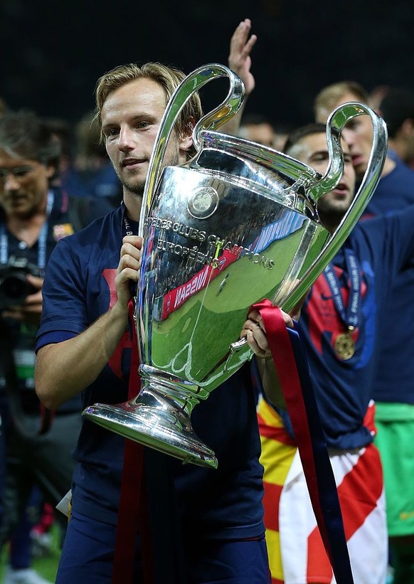 BERLIN, GERMANY - JUNE 6: Ivan Rakitic of FC Barcelona celebrates with the trophy following the UEFA Champions League Final match between Juventus and FC Barcelona at the Olympiastadion on June 6, 201 ...