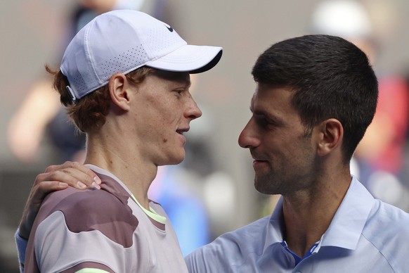 Jannik Sinner, left, of Italy is congratulated by Novak Djokovic of Serbia following their semifinal at the Australian Open tennis championships at Melbourne Park, Melbourne, Australia, Friday, Jan. 2 ...