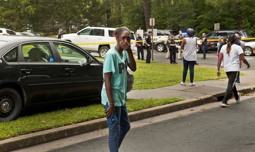 A woman reacts as she arrives on the scene of a shooting at Mount Tabor High School in Winston-Salem, N.C., Wednesday, Sept. 1, 2021. (Walt Unks/The Winston-Salem Journal via AP)