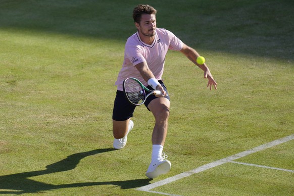 Stan Wawrinka of Switzerland plays a return to Frances Tiafoe of the United States during their singles tennis match at the Queen&#039;s Club Championships in London, Tuesday, June 14, 2022. (AP Photo ...