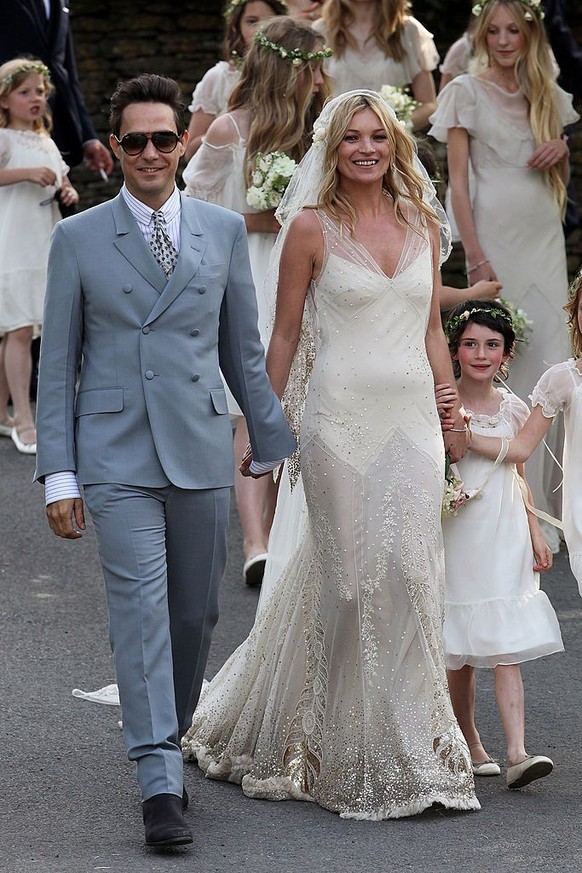 SOUTHROP, UNITED KINGDOM - JULY 01: Jamie Hince and Kate Moss outside the church after their wedding on July 1, 2011 in Southrop, England. (Photo by Neil Mockford/FilmMagic)