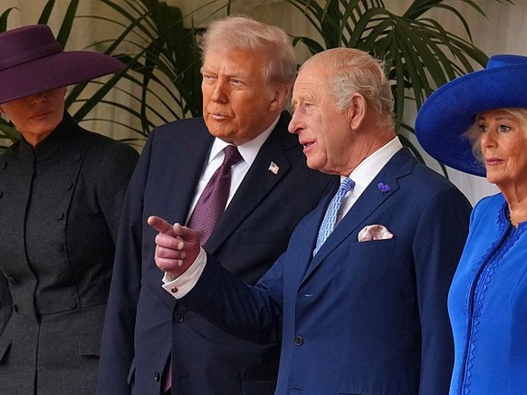 WINDSOR, ENGLAND - SEPTEMBER 17: President Donald Trump (2nd L) stands beside King Charles III (2nd R) and Queen Camilla (R) with Melania Trump (L) as they wait to review the Guard of Honour at Windso ...
