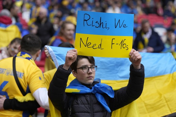 An Ukrainian fan waits for the start of the Euro 2024 group C qualifying soccer match between England and Ukraine at Wembley Stadium in London, Sunday, March 26, 2023. (AP Photo/Alastair Grant)