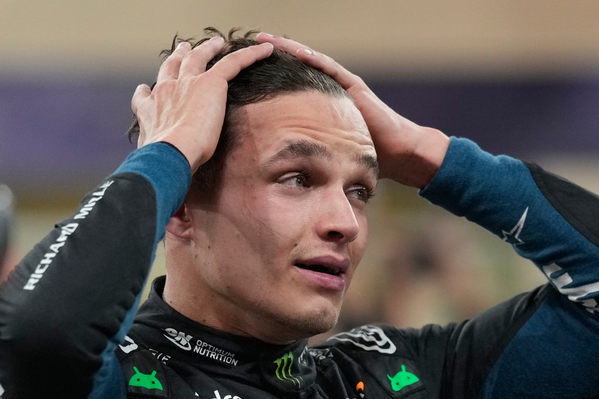 McLaren driver Lando Norris of Britain reacts after becoming a world champion after the Abu Dhabi Formula One Grand Prix in Abu Dhabi, United Arab Emirates, Sunday, Dec. 7, 2025. (AP Photo/Darko Bandi ...