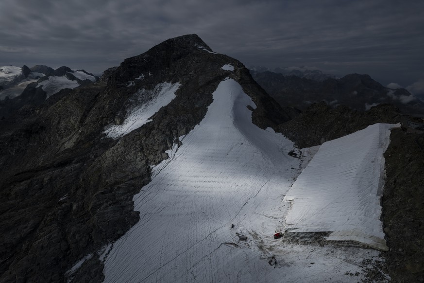 FILE --Parts of the ice of the Corvatsch glacier are covered with a tarpaulin, near Samedan, Switzerland, Monday, Sept. 5, 2022. Glaciologists have stopped their program to measure the glacier. The de ...