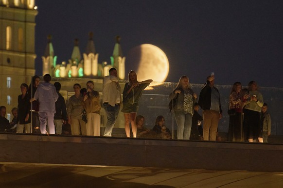A partial lunar eclipse is seen over the Floating Bridge as people enjoy a warm autumn evening at Zaryadye park in Moscow, Sunday, Sept. 7, 2025. (AP Photo/Alexander Zemlianichenko)
Russia Lunar Eclip ...