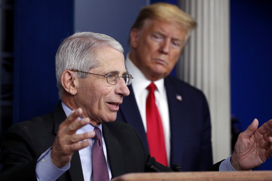 FILE - President Donald Trump watches as Dr. Anthony Fauci, director of the National Institute of Allergy and Infectious Diseases, speaks about the coronavirus in the James Brady Press Briefing Room o ...