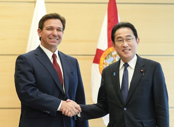 epa10588566 Florida Governor Ron DeSantis (L) shakes hands with Japanese Prime Minister Fumio Kishida (R) as he pays a courtesy call to Kishida at the latter&#039;s official residence in Tokyo, Japan, ...