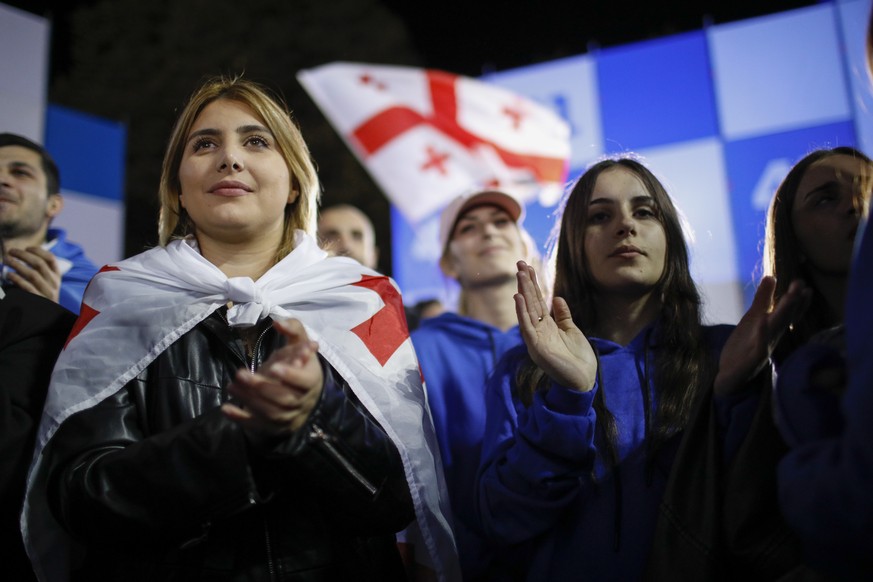 epa11685506 The Georgian Dream party supporters celebrate after exit poll results announcement in parliamentary elections at the Georgian Dream party headquarters in Tbilisi, Georgia, 26 October 2024. ...