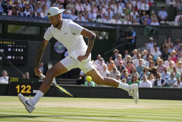 Australia's Nick Kyrgios returns the ball from between his legs to Serbia's Novak Djokovic in the final of the men's singles on day fourteen of the Wimbledon tennis championships in Lon ...