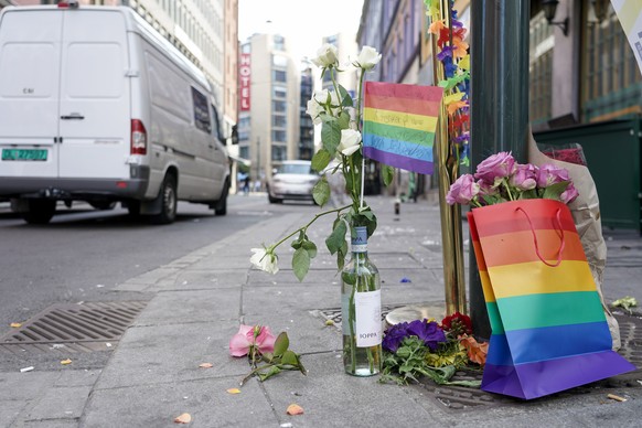 Flowers are left at the scene of a shooting in central Oslo, Saturday, June 25, 2022. Norwegian police say they are investigating an overnight shooting in Oslo that killed two people and injured more  ...