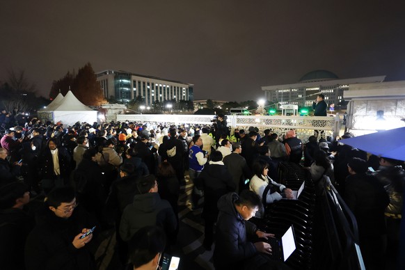 epa11754582 The main gate of the National Assembly in Seoul is crowded with people as police block entry following President Yoon Suk Yeol&#039;s declaration of martial law in Seoul, South Korea, 03 D ...