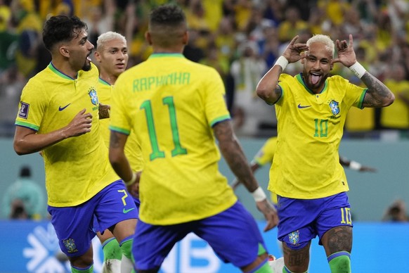 Brazil's Neymar, right, celebrates with team mates after scoring his side's second goal during the World Cup round of 16 soccer match between Brazil and South Korea, at the Stadium 974 in Al Rayyan, Q ...