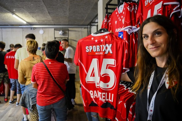 A saleswoman presents the new jersey of the new player Sion&#039;s forward Mario Balotelli of Italy in the club&#039;s store during the Super League soccer match of Swiss Championship between FC Sion  ...