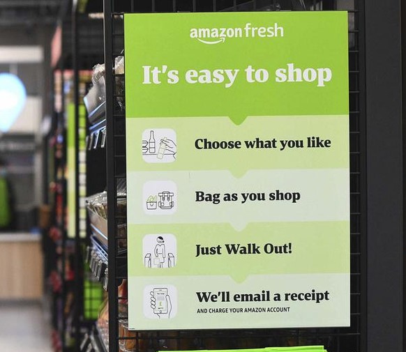 The Amazon Fresh grocery store opens in London, Thursday March 4, 2021, where a sign explains for shoppers to pick up items and walk out of the store, contactless, without the need for a till. Custome ...