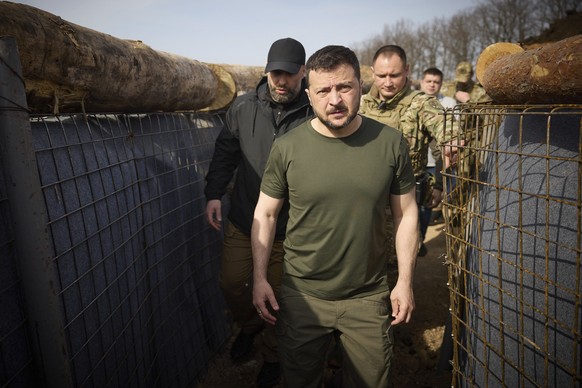 In this photo provided by the Ukrainian Presidential Press Office, Ukrainian President Volodymyr Zelenskyy inspects the fortification lines in Kharkiv region, Ukraine, Tuesday, April 9, 2024. (Ukraini ...