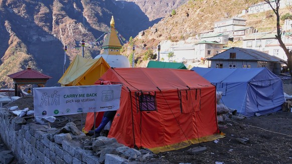 Carry me back project in Namche Bazar asking tourists to take small bags of garbage down to Lukla., Namche Bazar, Nepal - 11 27 2019: Carry me back project in Namche Bazar asking tourists to take smal ...