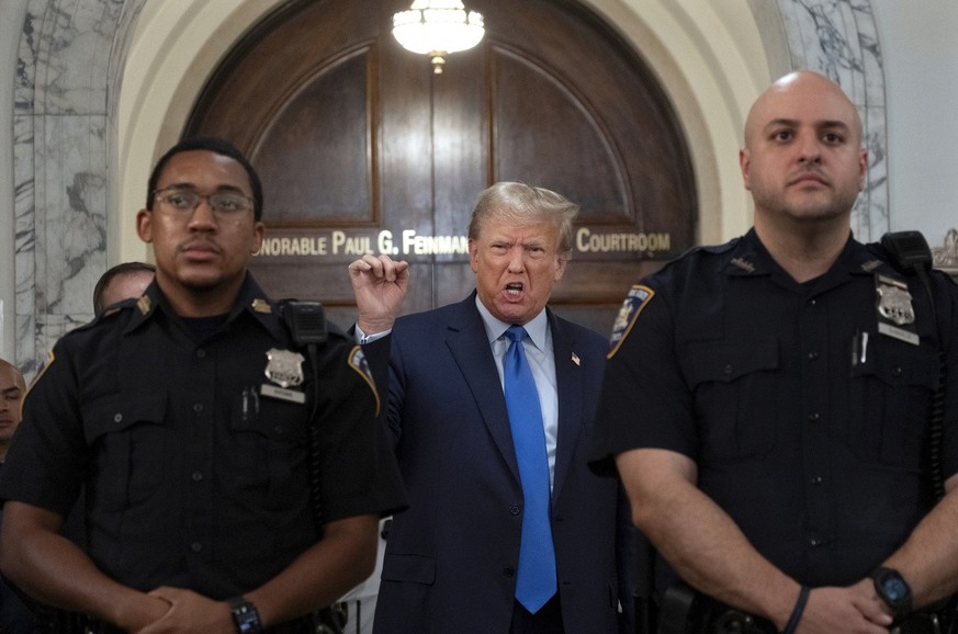 Former President Donald Trump speaks with journalists during a midday break from court proceedings in New York Monday, Oct. 2, 2023, as he attends the start of a civil trial in a lawsuit that already  ...