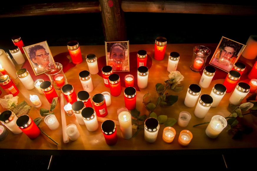 Portraits of three women who were killed and candles are pictured during a walk in tribute to the victims in the street of Daillon, Switzerland, Saturday, January 5, 2013. Late Wednesday, January 2, a ...