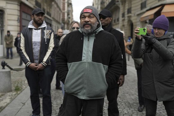Dieudonne M&#039;Bala M&#039;Bala, a French comedian repeatedly convicted of inciting antisemitism or racial hatred, stays outside Notre Dame du Val-de-Grace church during a public memorial for late f ...