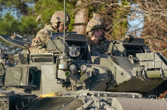 SALISBURY, ENGLAND - NOVEMBER 23: Prince William, Prince of Wales, Colonel-in-Chief, 1st Battalion Mercian Regiment (L) listens to a briefing ahead of an attack exercise during a visit to the regiment ...