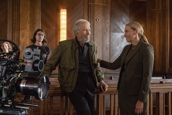 This image released by Warner Bros. Entertainment shows director Clint Eastwood, left, and Toni Collette behind the scenes during production for &quot;Juror #2&quot;. (Warner Bros. Entertainment via A ...