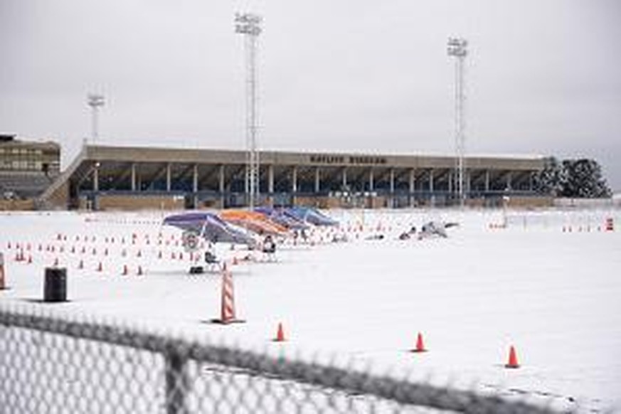 The mass vaccination clinic put on by Medical Center Hospital and the City of Odessa at Ratliff Stadium is seen covered in snow and ice Saturday, Feb. 13, 2021 in Midland, Texas. Subfreezing temperatu ...