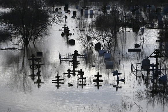 A flooded cemetery after part of a dam burst, in Orsk, Russia. State media say Russia&#039;s government has declared the situation in flood-hit areas in the Orenburg region a federal emergency. The fl ...