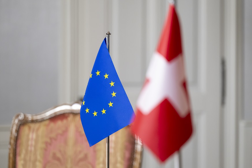 A Swiss flag, right, and an European flag, left, stand in a room prior to a working visit by Swiss Federal Councillor Ignazio Cassis to Maros Sefcovic, Vice-President of the European Commission, at th ...