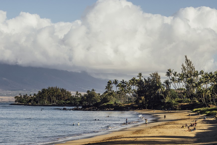 Beachgoers are seen at Kamaole Beach Park I in Kihei on the island of Maui, Hawaii Friday, Aug. 18, 2023.(Stephen Lam/San Francisco Chronicle via AP)