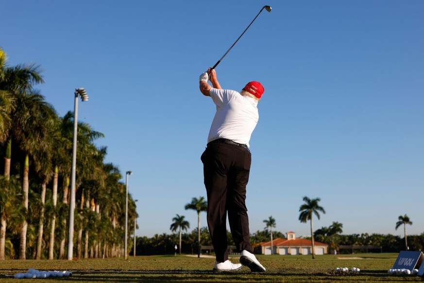 DORAL, FLORIDA - OCTOBER 27: Former U.S. President Donald Trump plays a shot on the driving range during a pro-am prior to the LIV Golf Invitational - Miami at Trump National Doral Miami on October 27 ...