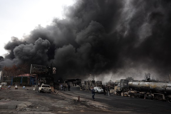epa12804499 A view of the Main gate to the Shahran Oil Refinery as smoke still rises following last night airstrike in Tehran, Iran, 08 March 2026. A joint Israeli and US military operation continues  ...