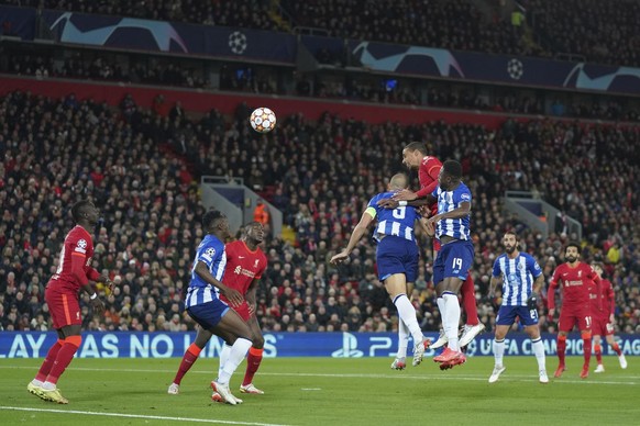 Liverpool&#039;s Joel Matip, top, attempts a head at goal in front of Porto&#039;s Pepe, left, and Porto&#039;s Chancel Mbemba during the Champions League group B soccer match between Liverpool and FC ...