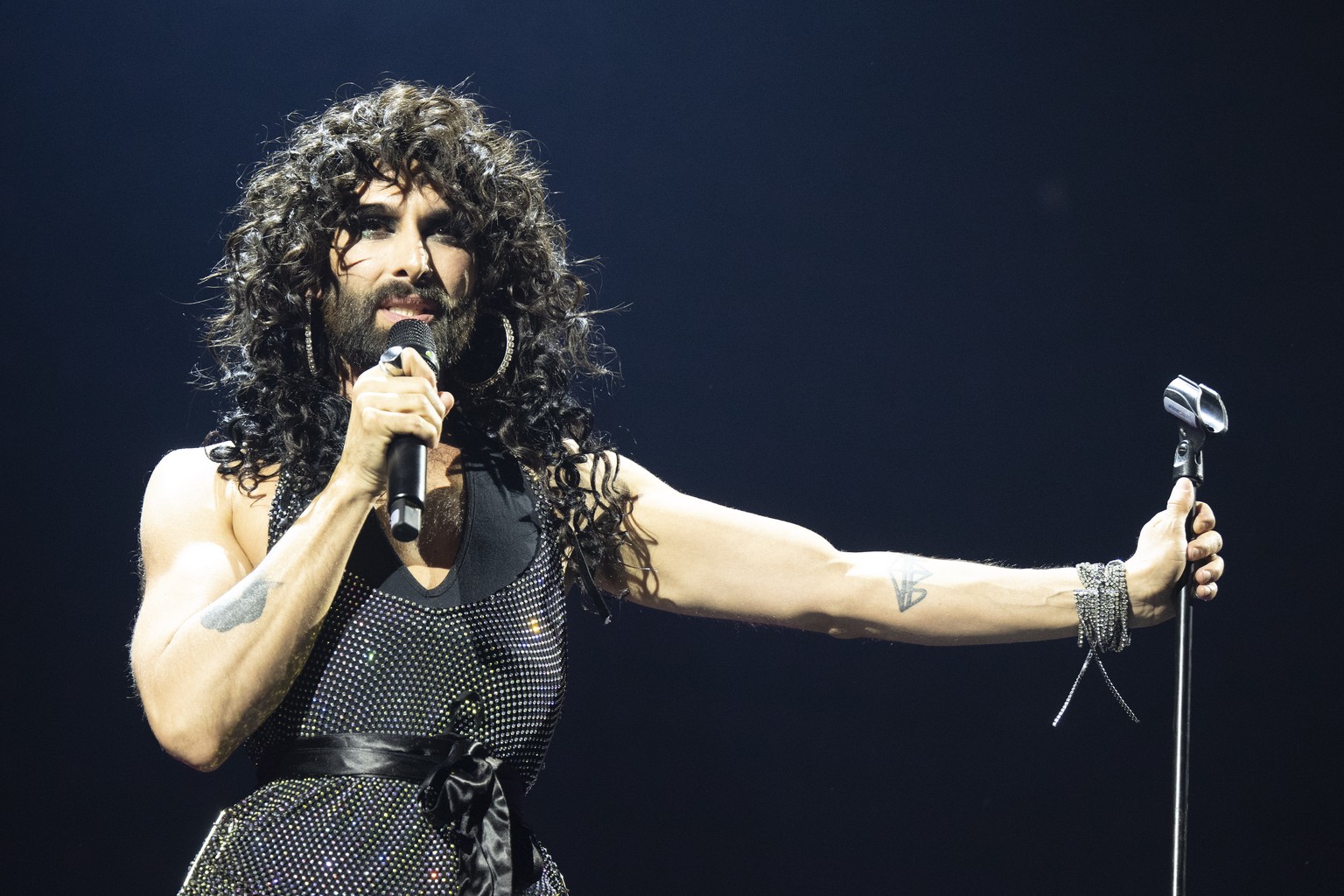 epa12094944 Austrian singer-songwriter Conchita Wurst performs onstage at the Eurovision Village of the 69th Eurovision Song Contest (ESC) in Basel, Switzerland, 12 May 2025. The semi-finals of the ES ...