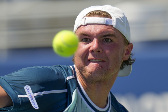 Dominic Stricker, of Switzerland, returns a shot to Stefanos Tsitsipas, of Greece, during the second round of the U.S. Open tennis championships, Wednesday, Aug. 30, 2023, in New York. (AP Photo/Manu  ...