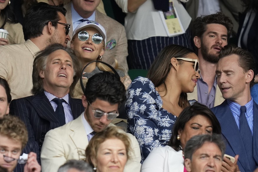 Actor Andrew Garfield, top right, singer Ariana Grande, top center, and actor Tom Hiddleston, middle right, sit in the stands on Centre Court for the final of the men&#039;s singles between Spain&#039 ...