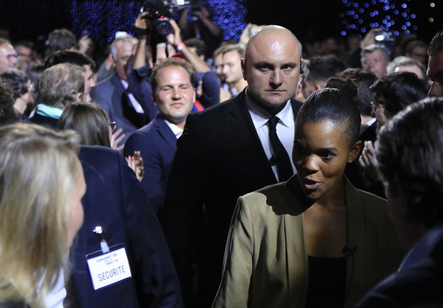 Candace Owens, director of urban engagement for Turning Point USA, right, looks at Marion Marechal, niece of far-right leader Marine Le Pen, left, as she arrives at the Convention of the Right, in Par ...