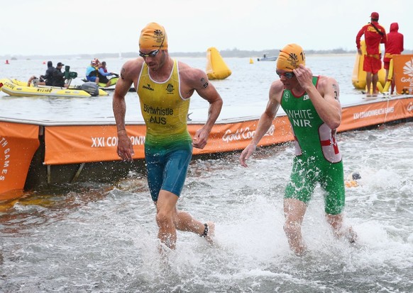 GOLD COAST, AUSTRALIA - APRIL 05: Jacob Birtwhistle of Australia and Russell White of Northern Ireland leave the water during the Men&#039;s Triathlon on day one of the Gold Coast 2018 Commonwealth Ga ...