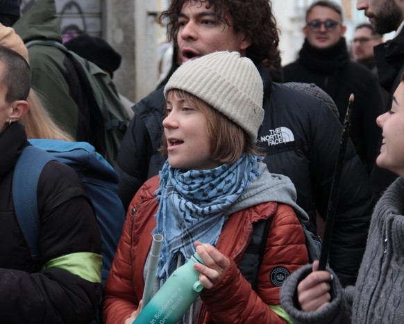 epa12541914 A photo released by Extinction Rebellion shows climate activist Greta Thunberg during a protest in which activists dyed Venice?s Grand Canal green in Venice, Italy, 22 November 2025. The g ...