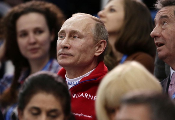 Russian President Vladimir Putin attends the figure skating competition at the Iceberg Skating Palace during the 2014 Winter Olympics, Sunday, Feb. 9, 2014, in Sochi, Russia. (AP Photo/Bernat Armangue ...