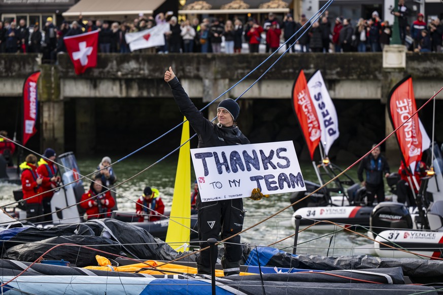 Skipper Justine Mettraux of Switzerland reacts as she passes through the channel aboard her IMOCA Teamwork-Team Snef after crossing the finish line during the Vendee Globe round-the-world solo sailing ...
