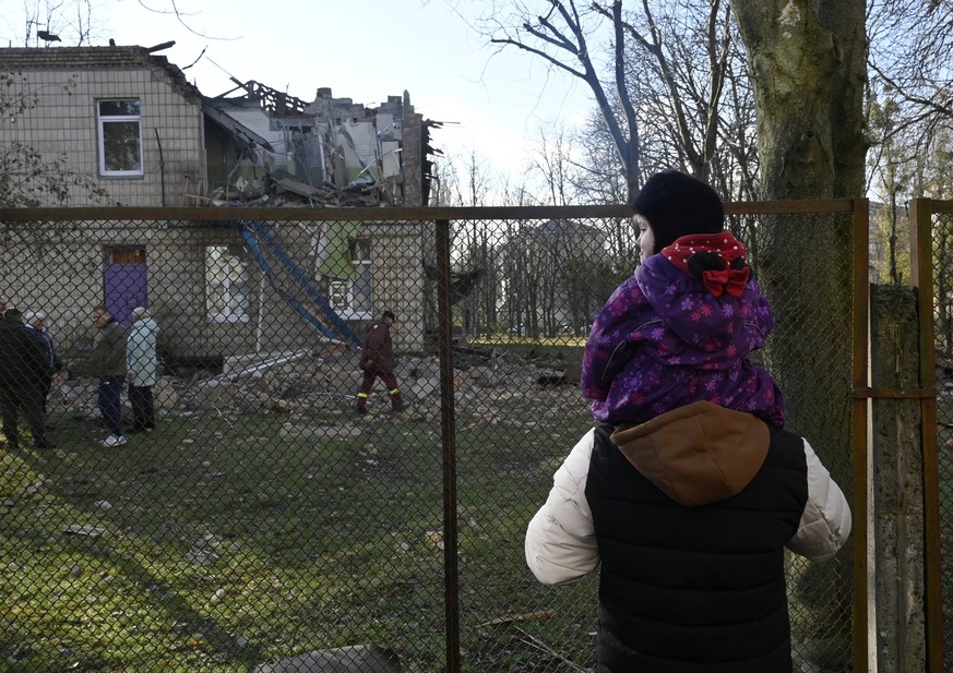 Attack by an Shahed drone of the Russian army in Kyiv - 25 Nov 2023 Man and child look at the kindergarten school that was damaged during an Iranian Shahed drones attacks in Kyiv. The Russian army att ...