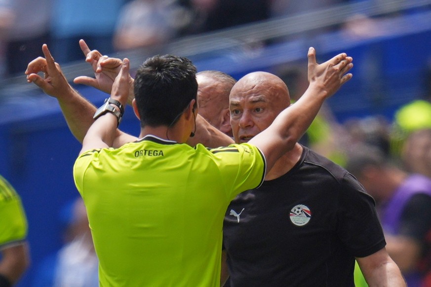 Referee Ramon Abatti gestures as he speaks to Egypt head coach Hossam Hassan on the sidelines during the World Cup Group G soccer match between Belgium and Egypt in Seattle, Monday, June 15, 2026. (AP ...