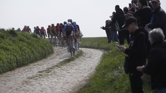epa10566139 The pack of riders in action during the 120th edition of the Paris-Roubaix cycling over 256.6km, France, 09 April 2023. EPA/YOAN VALAT