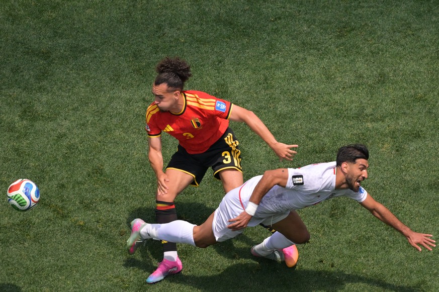 Belgium's Arthur Theate (3) and Iran's Shahriyar Moghanloo (20) fight for the ball during the World Cup Group G soccer match between Belgium and Iran in Inglewood, Calif., near Los Angeles,  ...