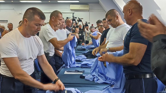 Serb police officers took off their uniforms in the town of Zvecan, Kosovo, Saturday, Nov. 5, 2022. Representatives of the ethnic Serb minority in Kosovo on Saturday resigned from their posts in prote ...