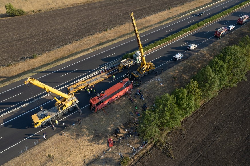 epa13173210 An aerial photograph taken by drone shows emergency services attending the scene after a tourist bus travelling from Poland went off the road and overturned in a ditch along the M3 motorwa ...