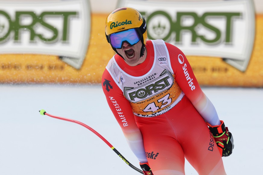 Switzerland's Alessio Miggiano celebrates at the finish area of an alpine ski, men's World Cup downhill, in Val Gardena, Italy, Saturday, Dec. 20, 2025. (AP Photo/Alessandro Trovati)
Italy W ...