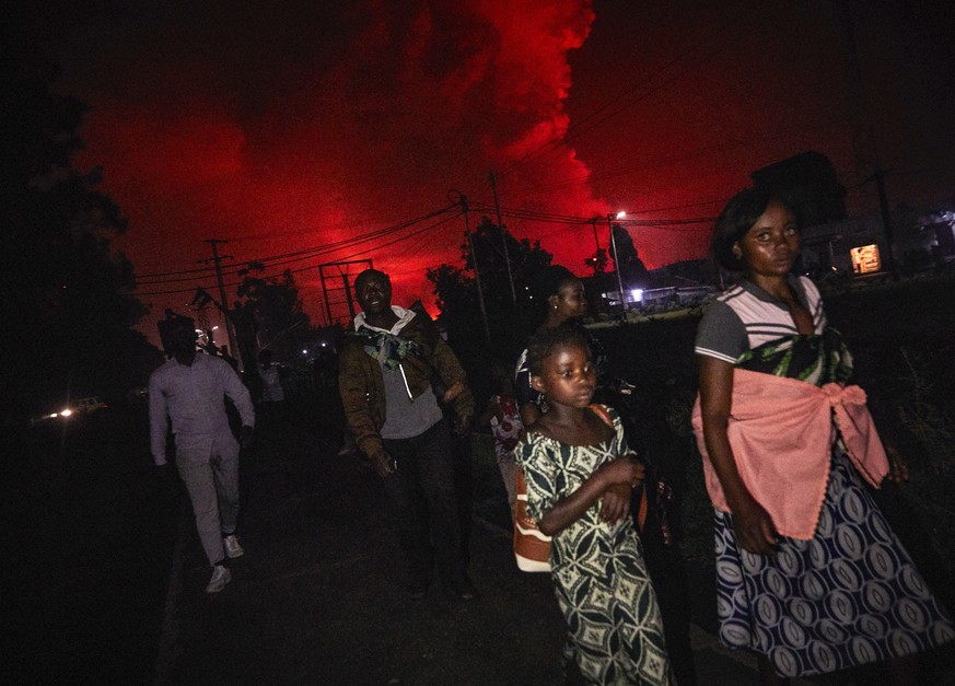 epa09221145 Congolese residents of Goma flee from Mount Nyiragongo volcano as it erupts over Goma, Democratic Republic of the Congo, 22 May 2021. One of the planets most active volcanoes Mount Nyirago ...